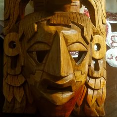 a carved wooden mask sitting on top of a table