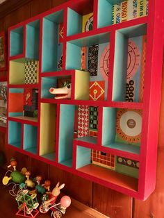 the shelves are made out of colorful bookshelves and play toys on top of them