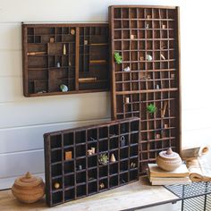 an assortment of wooden boxes and containers on a table with other items in the background