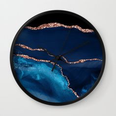 a clock with blue and gold paint on it