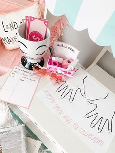 a desk with pink and white items on it, including a sign that says hello kitty