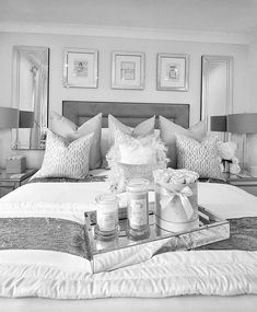 black and white photograph of a bedroom with candles on the bed in front of it