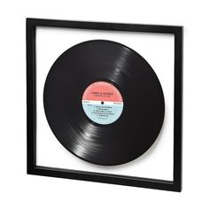 an old record in a black frame