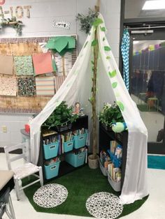 an indoor tent with plants and books in it