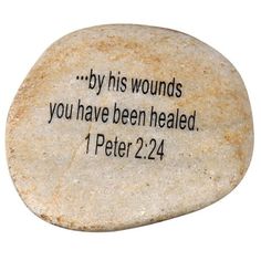 a stone with the words by his wounds you have been healed 1 peter 22