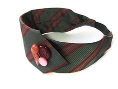 a green and red plaid tie with a pink button on it's center piece