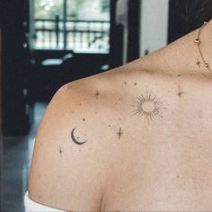 a woman's chest with stars and the moon on it