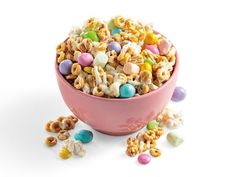 a pink bowl filled with cereal and candy