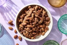 a bowl full of nuts sitting on top of a table