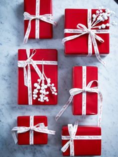 red wrapped gifts with white ribbons and bows