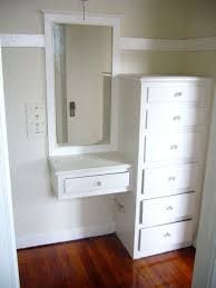 a white dresser and mirror in a room with hard wood flooring on the wooden floors