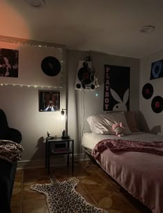 a bed room with a neatly made bed and pictures on the wall