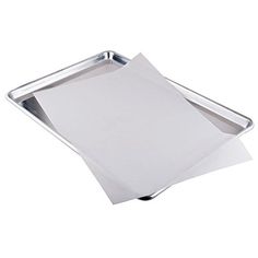 a metal tray with paper on top of it and a white sheet of paper in the bottom