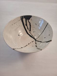 a black and white bowl sitting on top of a table