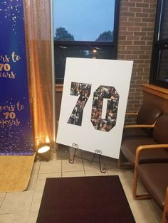 a sign with the number seventy on it in front of a chair and a window