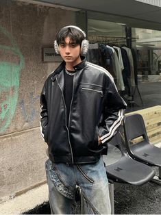 a young man wearing headphones standing in front of a bench