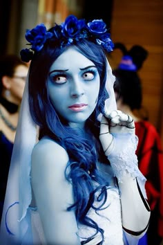 a woman with blue hair and makeup is dressed as corpse bride