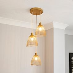 three lights hanging from the ceiling in a room