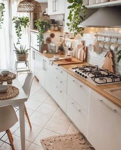 a kitchen filled with lots of counter top space and plants on the wall above it