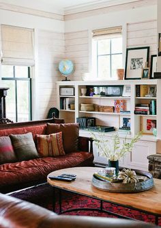 a living room filled with furniture and bookshelves next to a fire hydrant