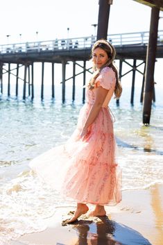 Expertly crafted with corset boning on the bodice, the Ever After Dress is made for a flattering fit. With a peach pink base and pink floral tulle overlay, this midi length dress features a sweetheart neckline, short puff sleeves, and a ruffle tiered skirt. The functional tie closure on the back adds the perfect detail! Ps. Floral pattern may vary from dress to dress! Available in sizes XXS, XS, S, M, L, XL, 1X, 2X, 3X, 4X, + 5X!! pink floral dress, floral dress, plus size fashion, matching Short Sleeve Maxi Dress For Summer Prom, Summer Short Sleeve Maxi Dress For Prom, Peach Short Sleeve Midi Dress For Brunch, Spring Midi Dress With Fitted Bodice And Short Sleeves, Peach Ruffled Midi Dress For Garden Party, Spring Prom Midi Dress With Short Sleeves, Peach Short Sleeve Midi Dress For Summer, Pink Flowy Tiered Skirt Dress, Short Sleeve Maxi Dress For Prom