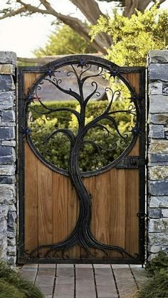 an iron gate with a tree on it