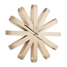 a clock made out of wooden sticks on a white background