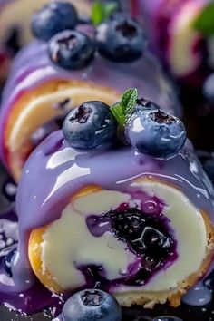 blueberry cheesecake roll with icing and fresh berries on top, ready to be eaten