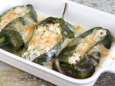 stuffed green peppers in a white casserole dish