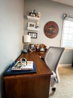 an office with a desk, chair and clock on the wall