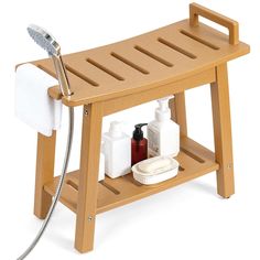 a wooden shower bench with soap and lotion on it