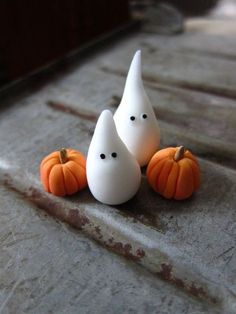 three small white pumpkins sitting next to each other