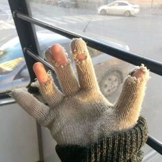 a hand with two fingers sticking out of it, sitting on a window sill