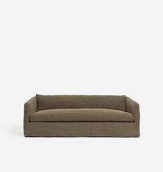 a brown couch sitting on top of a white floor