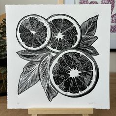 a black and white drawing of oranges with leaves