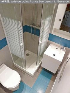 a white toilet sitting next to a walk in shower