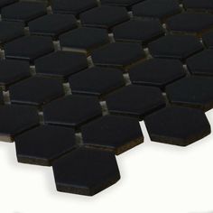 black hexagonal tiles are arranged in rows