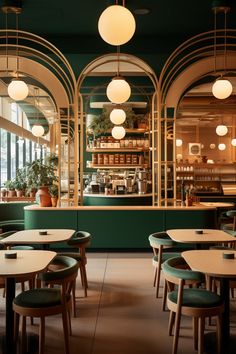 the interior of a restaurant with green walls and wooden tables, hanging lights and potted plants