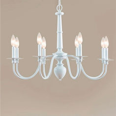 a white chandelier with six lights hanging from it's center and four arms