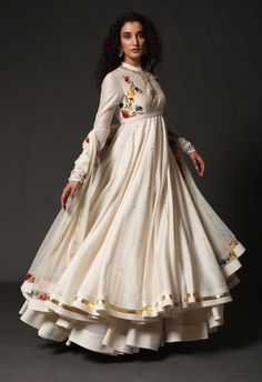 Editor's Note Chanderi Anarkali With Chanderi Dupatta Paired Up With Churidar Color: Ivory Fabric: Chanderi & Cotton Care: Dry Clean Only About the Designer Rohit Bal is intensely concerned with design as an art form. The designer draws on history, fantasy and folklore to create masterpieces that are desired by discerning aficionados around the globe. Rohit has a deep understanding of the psyche of the fashion world and it reflects in his collections that are intelligent, studied, imaginative an Luxury Silk Thread Anarkali Set With Pallu, Luxury Anarkali Set With Pallu, Luxury Designer Anarkali Set With Zari Work, Luxury Anarkali Dress With Zari Weaving, Luxury Anarkali Set With Zari Work For Puja, Luxury Anarkali Chinon Palazzo Set, Luxury Anarkali Choli With Resham Embroidery, Luxury Anarkali Churidar With Floral Print, Luxury Anarkali Salwar Kameez With Motifs