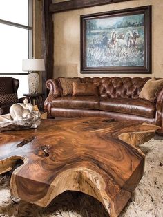 a living room filled with furniture and a large wooden table