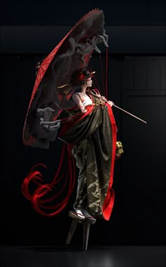 a woman dressed in red and black holding an umbrella while standing on top of a stool