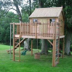 a wooden tree house with a swing set