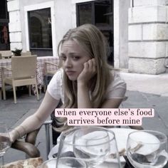 a woman sitting at a table with food in front of her and the caption reads, when everyone else's food arrives before mine