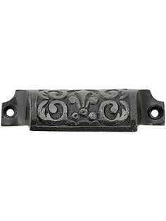 an ornate cast iron door handle on a white background