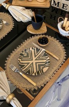 the table is set with plates and utensils