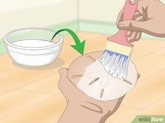 a person using a brush to clean their face with a bowl in the foreground