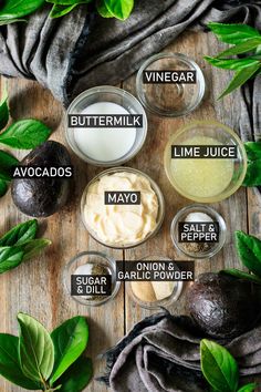 avocados, buttermilk, lime juice and other ingredients are arranged on a wooden surface