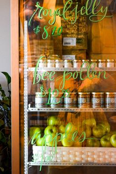 there is a display case with apples and yogurt on it in the store