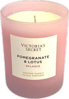 a pink candle with the label victoria's secret pomegranate and lotus